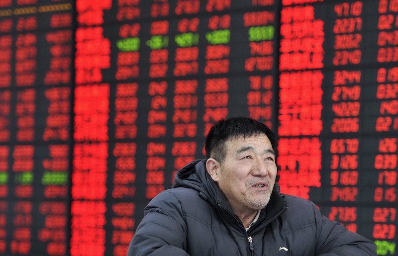 An investor looks on in front of an electronic board showing stock information at a brokerage house in Fuyang, Anhui province March 13, 2015. u00e2u20acu201d Reuters pic