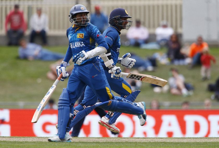 Sri Lankan batsman Tillakaratne Dilshan (L) and Kumar Sangakkara score runs at will Cricket World Cup match against Scotland in Hobart March 11, 2015. REUTERS/David Gray