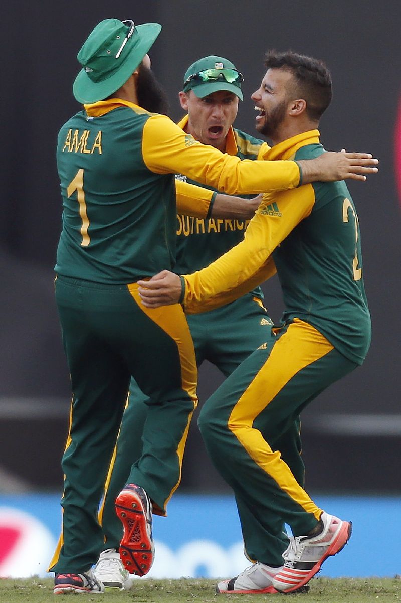 Jean-Paul Duminy (right) celebrates with teammates Imran Tahir (left) and Dale Steyne after he dismissed Tharindu Kaushal for a duck.