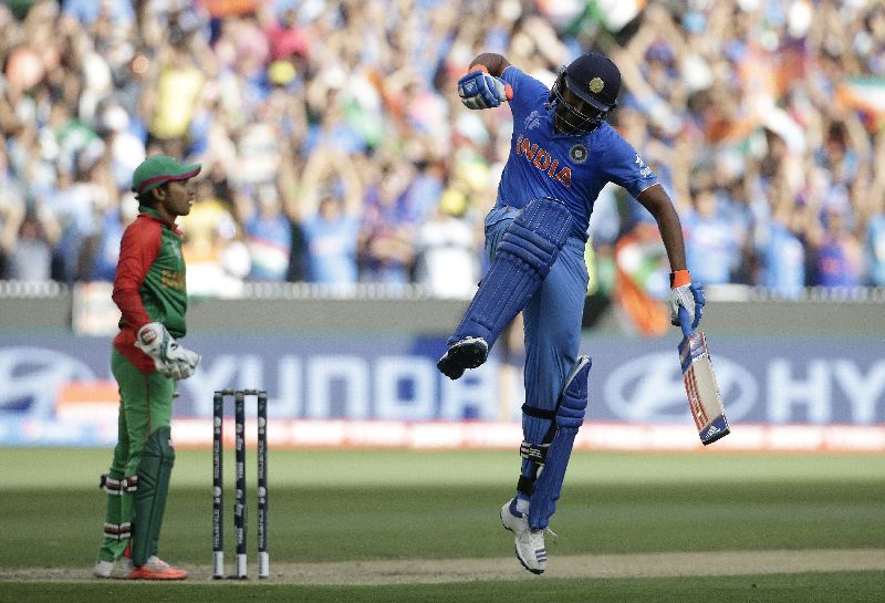 Indiau00e2u20acu2122s batsman Rohit Sharma jumps for joy after reaching his century during his Cricket World Cup quarter-final match against Bangladesh in Melbourne, March 19, 2015. REUTERS/Hamish Blair