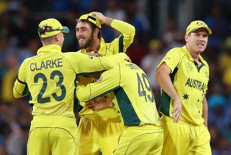 Australiau00e2u20acu2122s Glenn Maxwell (2nd L) celebrates with captain Michael Clarke after an official review resulted in the dismissal of Indiau00e2u20acu2122s Ajinkya Rahane Cricket World Cup semi-final in Sydney, March 26, 2015. REUTERS/Steve Christo