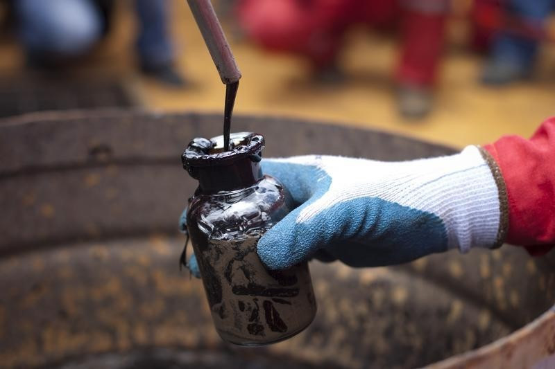 A worker collects crude oil sample at an oil well operated by Venezuela's state oil company PDVSA in Morichal July 28, 2011. u00e2u20acu201d Reuters pic