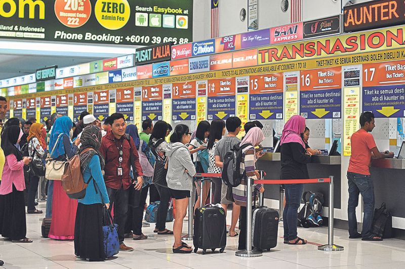 People queue up for bus tickets at the TBS Integrated Terminal in Bandar Tasik Selatan yesterday. Commuters say they have no choice but to live with the fare increases as they are unavoidable. u00e2u20acu2022 Malay Mail pic