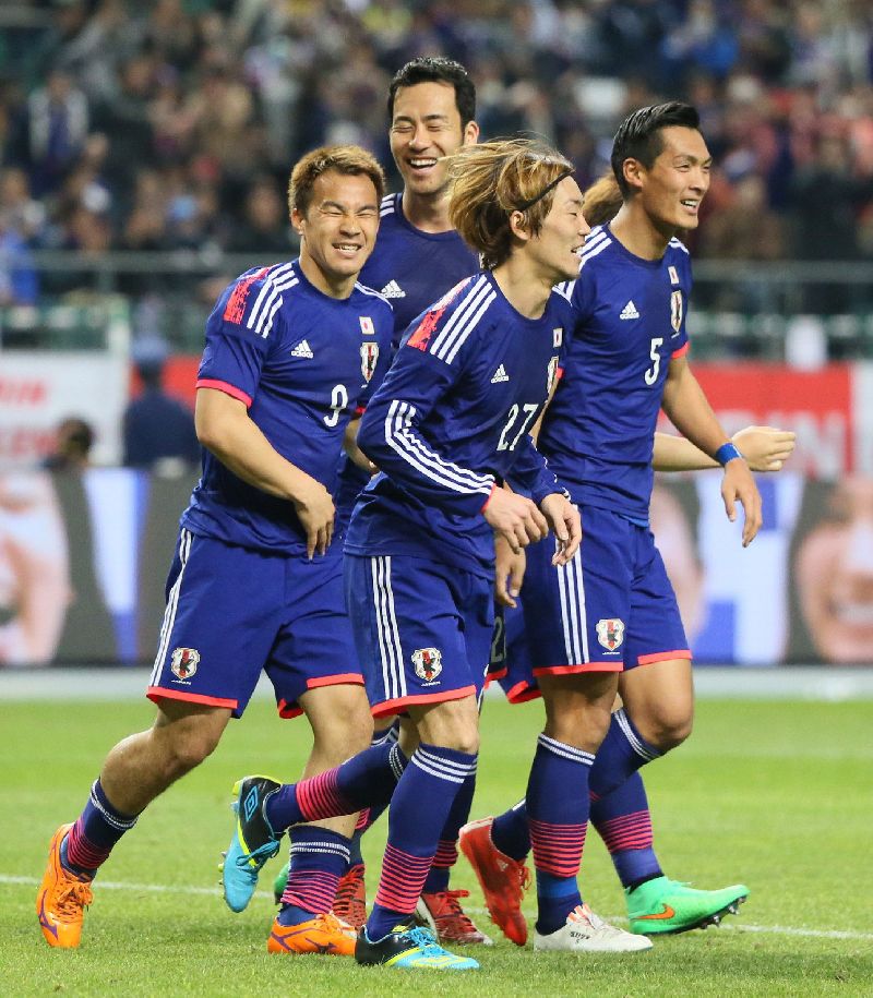Japanu00e2u20acu2122s forward Shinji Okazaki (L) celebrates with his teammates after he scored a goal against Tunisia international friendly in Oita in Japanu00e2u20acu2122s southern island of Kyushu March 27, 2015. Japan defeated Tunisia 2-0. AFP PHOTO / JIJI PRESS 