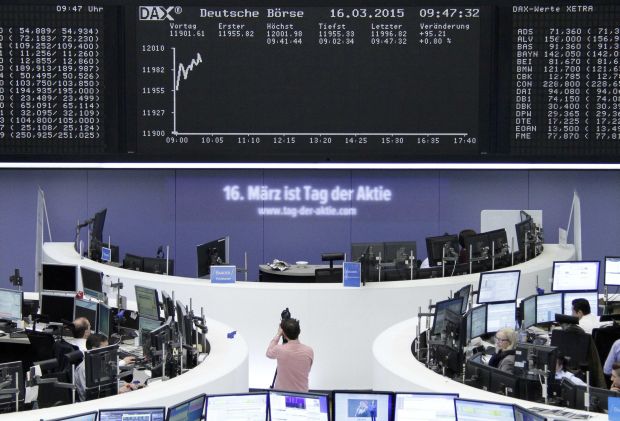 Traders work at their screens in front of the German share price index DAX board at the stock exchange in Frankfurt March 17, 2015. u00e2u20acu2022 Reuters pic