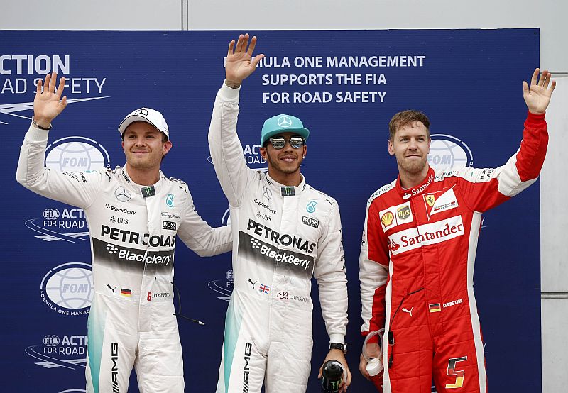(from left) Mercedes' Nico Rosberg and Lewis Hamilton with Ferrari's Sebastian Vettel after qualifying. Hamilton qualified in first place with Vettel and Rosberg in second and third place respectively. u00e2u20acu201d Reuters pic