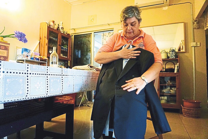 Gonzales holds on to Gomes's uniform. She says many of his things at home remain as they were. — Picture by Ahmad Zamzahuri