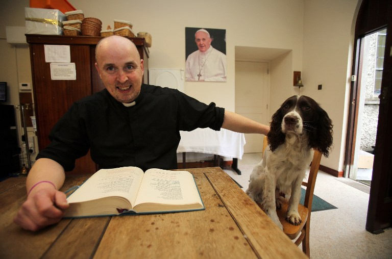 Irish Catholic priest Pierre 'Jalapeno' Pepper with his dog Cosmo in his church house of St Rynaghs in Banagher, Republic of Ireland on March 14, 2015. u00e2u20acu201d AFP pic