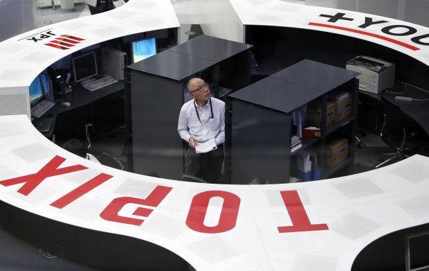 An employee of the Tokyo Stock Exchange (TSE) looks at a stock quotation board as he works at the bourse at TSE in Tokyo. u00e2u20acu2022 Reuters pic