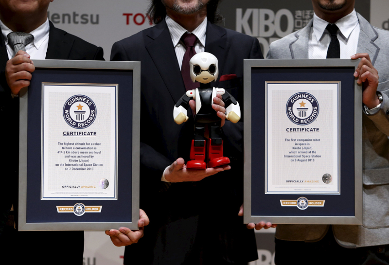 Humanoid communication robot Kirobo is displayed for pictures with two Guinness World Record certificates during a return debriefing session from the International Space Station to Japan, in Tokyo March 27, 2015. u00e2u20acu201d Reuters pic