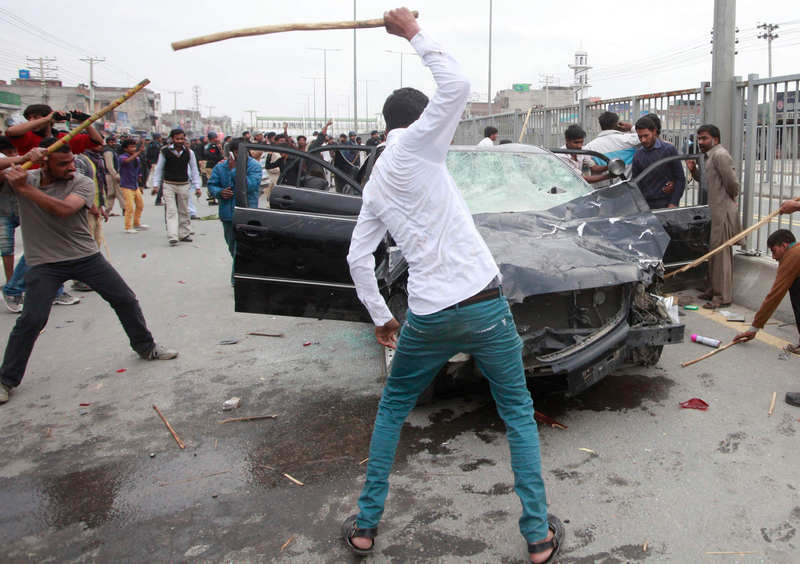 Protesters from the Christian community attack a car during clashes with riot police, a day after suicide attacks on two churches in Lahore March 16, 2015. u00e2u20acu201d Reuters pic