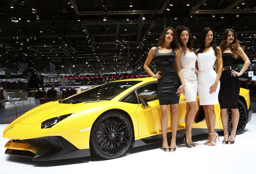Models pose next to a Lamborghini Aventador SV sports car during the second press day ahead of the 85th International Motor Show in Geneva March 4, 2015. — Reuters pic