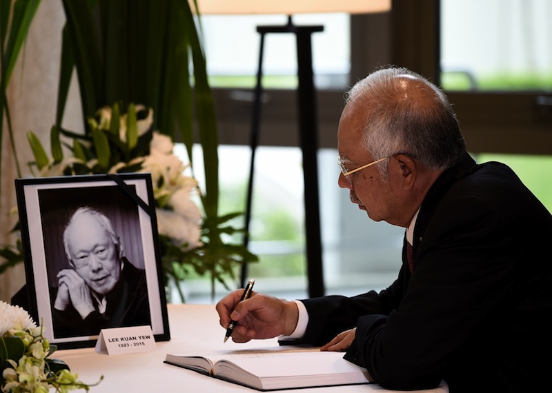 Prime Minister Datuk Seri Najib Razak signing a condolence book for Singapore's former prime minister Lee Kuan Yew at Singapore's High Commission in Kuala Lumpur on March 24, 2015. u00e2u20acu201d AFP pic