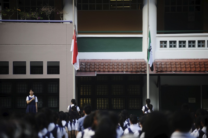 The state flag is pictured at half-mast as the National Pledge is recited during morning assembly at Raffles Girls Secondary School in Singapore March 23, 2015. u00e2u20acu201d Reuters pic