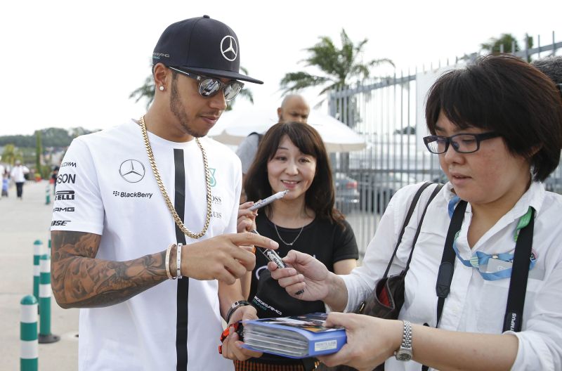Mercedes' Lewis Hamilton signs autographs for fans at the Sepang International Circuit, Kuala Lumpur. u00e2u20acu2022 Reuters pic