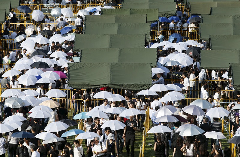 People shield themselves with umbrellas, as they queue up to pay their respects to the late first prime minister Lee Kuan Yew, at the Parliament House in Singapore, March 27, 2015 u00e2u20acu201d Reuters pic    