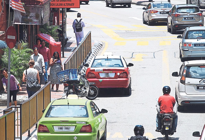 Taxis operating at tourist hotspots like the Lot 10 shopping mall refuse to use the meter, insisting on a flat rate instead. u00e2u20acu201d Picture by Azneal Ishak