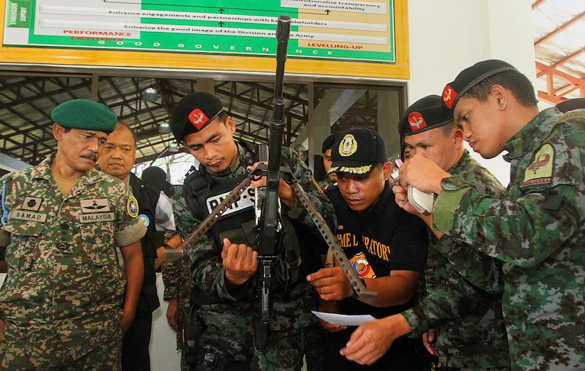 Philippine police commandos and officers inspect high powered firearms at a military camp in Cotabato, in the southern island of Mindanao on February 18, 2015. u00e2u20acu201d AFP pic