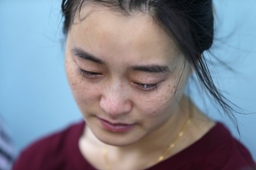 A woman, whose son was aboard the missing Malaysia Airlines flight MH370, reacts after she and other family members failed to express their appeals to the airline outside its office in Beijing in this June 11, 2014 file photo. u00e2u20acu201du00c2u00a0Reuters pic