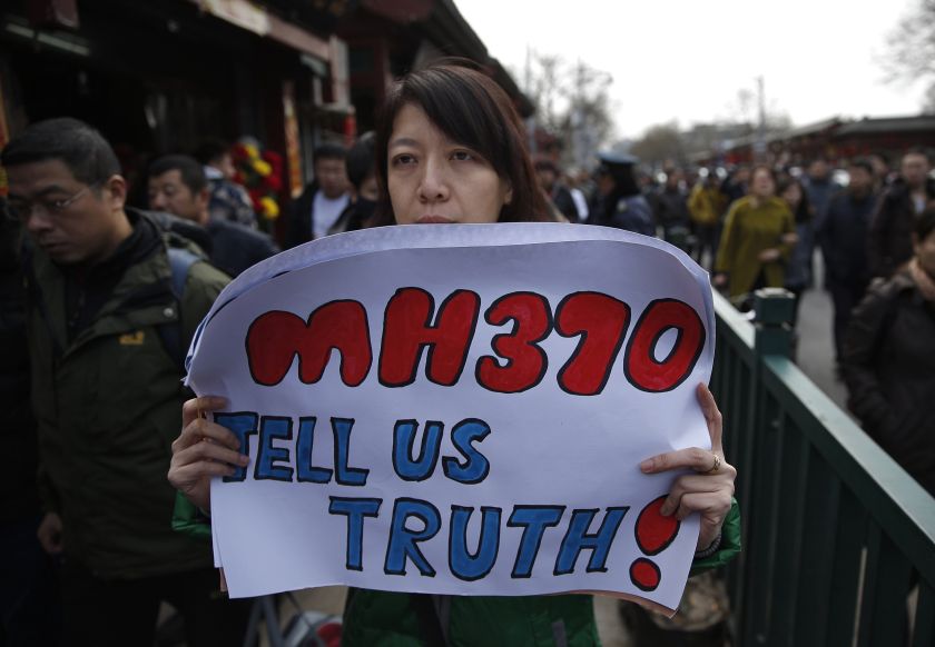 Catherine Gang holds a banner as she walks outside Yonghegong Lama Temple after a gathering of family members of the missing passengers in Beijing March 8, 2015. u00e2u20acu2022 Reuters pic