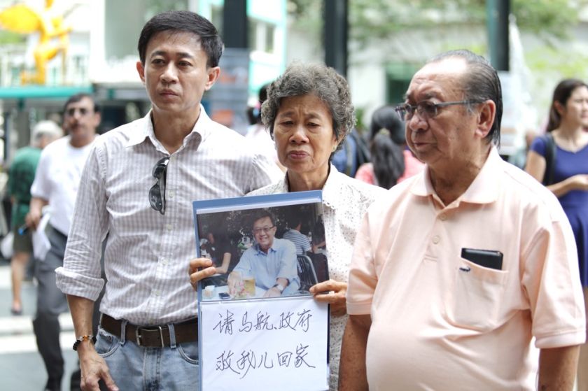 Family members of a passenger on board MH370 are seen holding a photo of their loved one during the MH370 Remembrance Day at Publika, March 8, 2015. u00e2u20acu2022 Picture by Choo Choy May