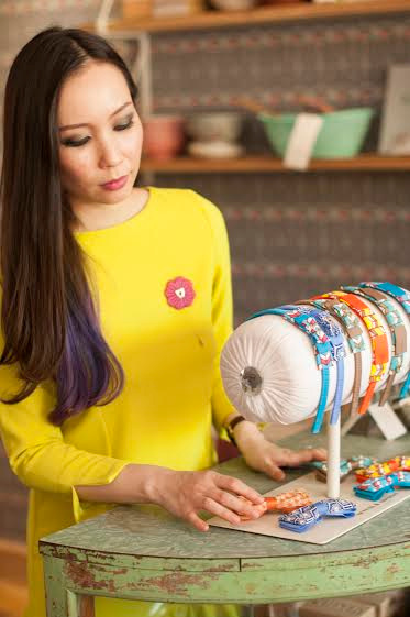 Sereni Linggi sports a Pretty in Peranakan buttonaire, as she examines the Nala selection of headbands and Eton bow ties.