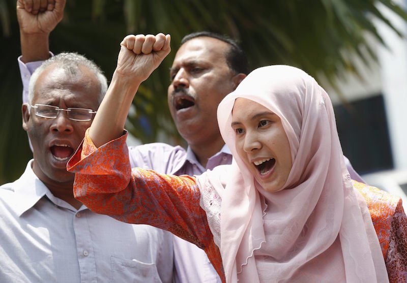 Nurul Izzah Anwar leads a chant after she is released on bail from a police station in Kuala Lumpur March 17, 2015. u00e2u20acu201d Reuters pic