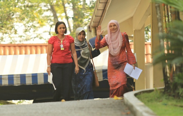Nurul Izzah Anwar retrieving the hardcopy of the Parliament speech from her house before being escorted back to Dang Wangi Police Station, Kuala Lumpur, March 17, 2015. u00e2u20acu201d Picture by Saw Siow Feng