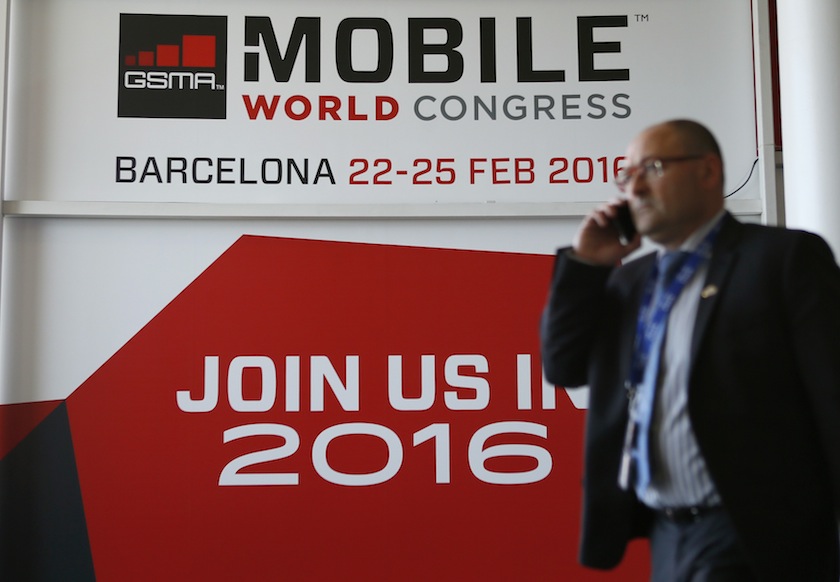 A man talks by phone while he walks past the 2016 Mobile World Congress edition banner in Barcelona March 5, 2015. u00e2u20acu201d Reuters pic