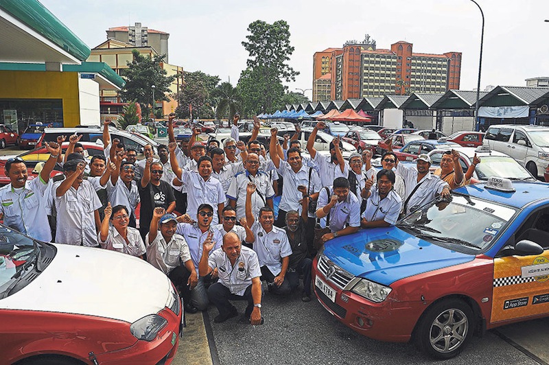 Some of the taxi drivers from 17 associations who voiced out their disappointment at the prospects of going back to the old rates. u00e2u20acu201d Picture by Hafiz Sohaimi