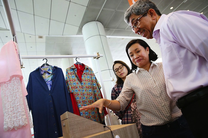 Minister for Communications and Information Dr Yaccob Ibrahim viewing the trailer for Centerpoint Kids with film director Wee Li Lin during the launch of 'Past Forward'.u00c2u00a0u00e2u20acu201d TODAY pic by Don Wong