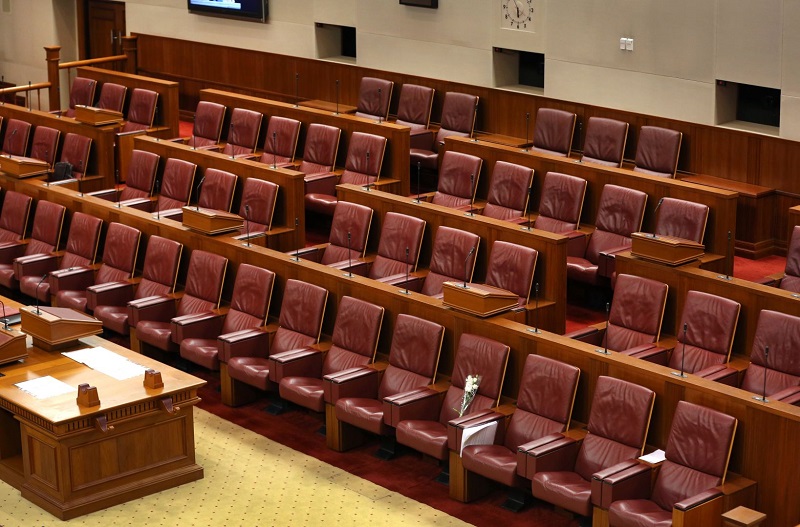 Flowers are seen at the seat of the late Lee Kuan Yew in Parliament before the special parliament sitting in Singapore, March 26, 2015. u00e2u20acu201d Today pic