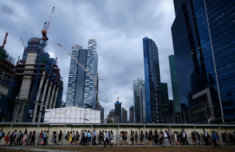 Office workers walk during evening rush hour in the financial district of Singapore March 9, 2015. Lee Kuan Yew's growth legacy has left behind a thriving and undisputed global success story. u00e2u20acu201d Reuters pic