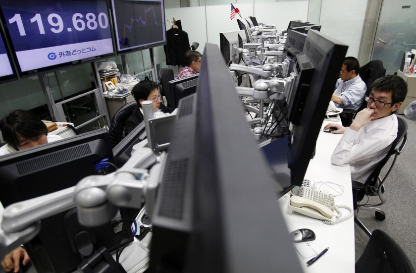 Employees of a foreign exchange trading company work in front of a monitor, displaying the exchange rates between the Japanese yen and the US dollar, in Tokyo, March 5, 2015. u00e2u20acu2022 Reuters pic