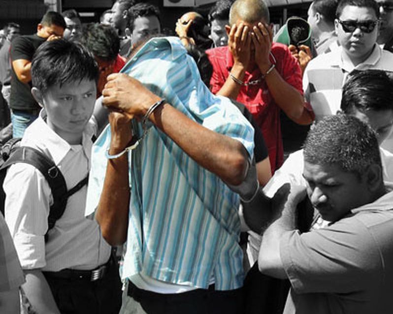 Some of the 14 men and women being led out of the magistrateu00e2u20acu2122s court after they were remanded for seven days by the MACC for alleged corruption in the procurement of items for the Royal Malaysian Navy base in Lumut. u00e2u20acu2022 Malay Mail pic