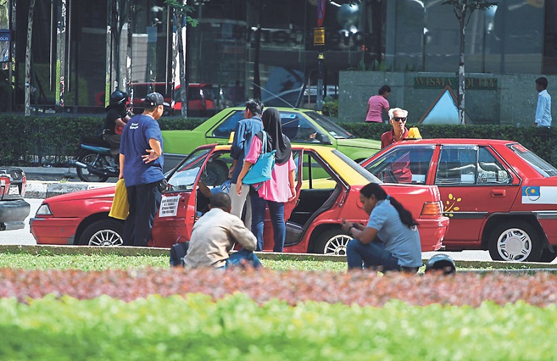 Passengers in Kuala Lumpur haggle with taxi drivers over fares. u00e2u20acu201d Picture by Azneal Ishak
