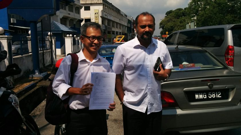 DAP MPs Tony Pua (left) and Gobind Singh Deo with a copy of the police report made at the Damansara Police Station in Petaling Jaya, March 4, 2015. u00e2u20acu201d Picture by Mayuri Mei Lin