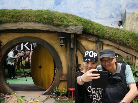 Passers-by stop for a quick photo at a scaled replica of a Hobbit hole at the departure hall of Changi Airport Terminal 3. u00e2u20acu201d TODAY 