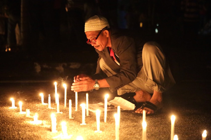 A man lights candles during a vigil for Datuk Seri Anwar Ibrahim outside the Sungai Buloh prison in Selangor March 5, 2015. u00e2u20acu201d Picture by Choo Choy May