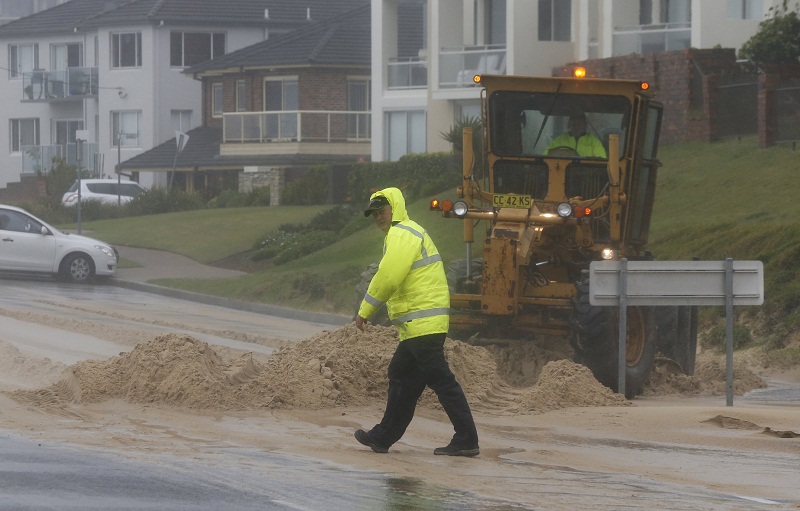 A loader moves tons of sand pushed by strong winds and rain onto a coastal road in Sydneyu00e2u20acu02dcs beachside suburb of Cronulla, April 21, 2015. u00e2u20acu201d Reuters pic