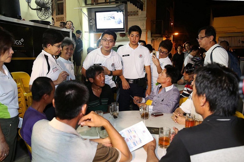 Marine Parade GRC MP Fatimah Lateef (second woman from left) and police officers from the Geylang Neighbourhood Police Centre educate the public at Geylang Lorong 40 last night about the consumption of liquor in public places. u00e2u20acu201d Today pic