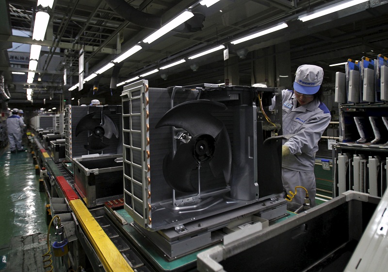A Daikin Industries Ltd employee inspects indoor air conditioning units at the production line at the companyu00e2u20acu2122s Kusatsu factory in Shiga prefecture, western Japan, April 5, 2015. u00e2u20acu201d Reuters pic