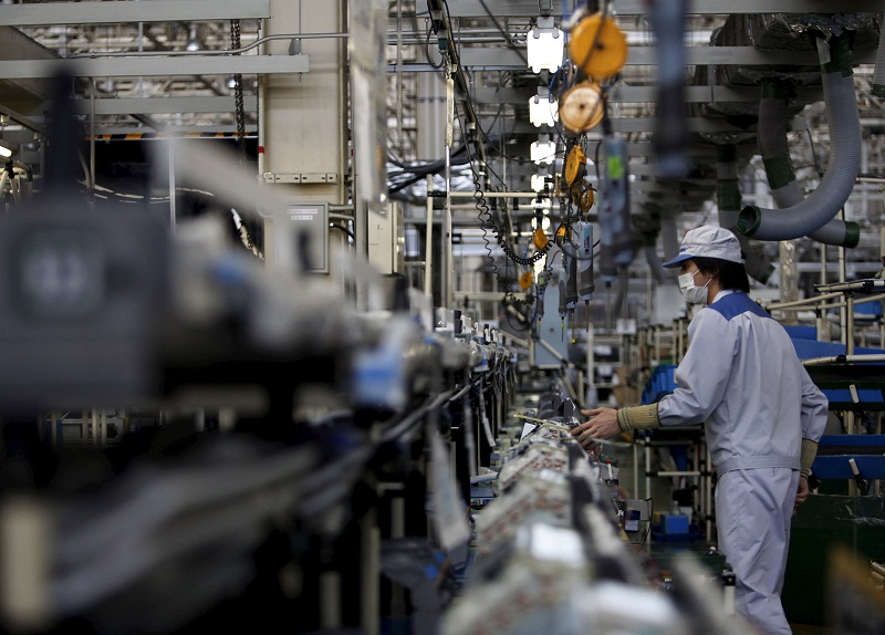 An employee of Daikin Industries Ltd works the production line of outdoor air conditioning units at the companyu00e2u20acu2122s Kusatsu factory in Shiga prefecture, western Japan, April 5, 2015. u00e2u20acu201d Reuters pic