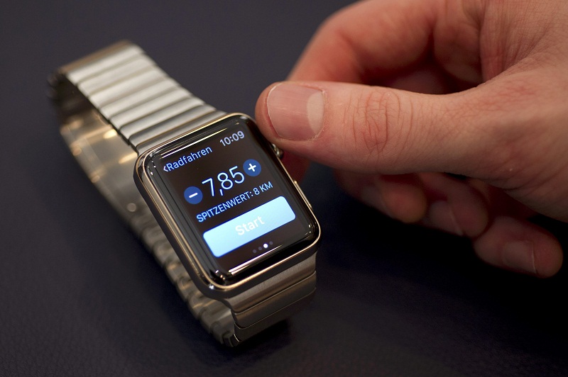 A salesman presents an Apple Watch to customers and journalists at an Apple Store in Berlin April 10, 2015. — Reuters pic