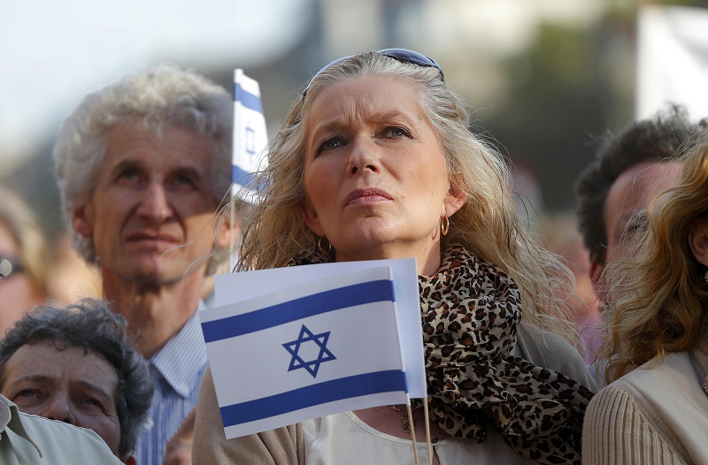 A woman holds an Israeli flag as she participates in the annual u00e2u20acu02dcMarch of the Livingu00e2u20acu2122 to commemorate the deaths of around half a million Hungarian Jews during the Holocaust in World War Two, in Budapest April 12, 2015. u00e2u20acu201d Reuters pic