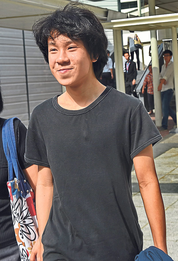 Amos Yee, a 16-year-old student, leaves the State courts in Singapore on March 31, 2015. — AFP Picture