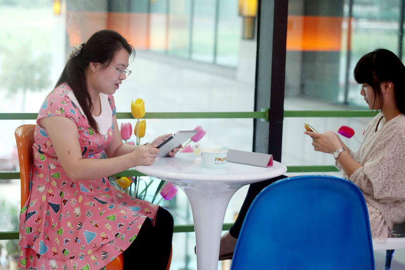 Women use portable devices to browse the Internet in a restaurant in Haikou, south Chinau00e2u20acu2122s Hainan province. Researchers claimed China seeks to shut down websites and services aimed at helping Chinese users circumvent government censorship. u00e2u20acu201d AFP pic
