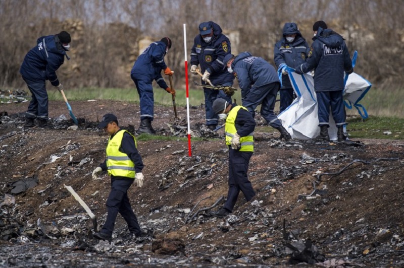Dutch and Malaysian investigators and local authorities work at the MH17 plane crash site near the village of Grabove in the self-proclaimed Donetsk People's Republic, April 16, 2015. u00e2u20acu201d AFP pic