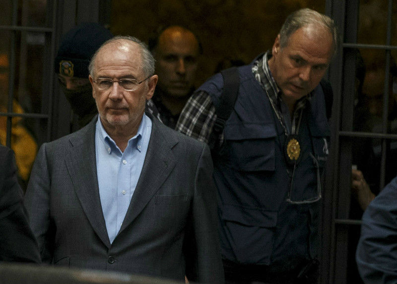 Rodrigo Rato (left), former Peopleu00e2u20acu2122s Party minister and former IMF managing director, is led by police as they left his residence after an inspection in Madrid, April 16, 2015. u00e2u20acu201d Reuters pic