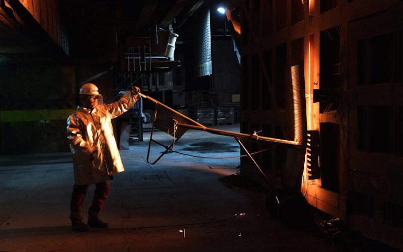 An employee stands in front of the blast furnace to take a specimen at the ThyssenKrupp steel mill Hamborn in Duisburg December 12, 2014. u00e2u20acu201d AFP pic 